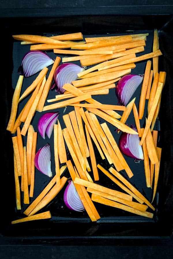 Sweet potato and red onion on baking tray
