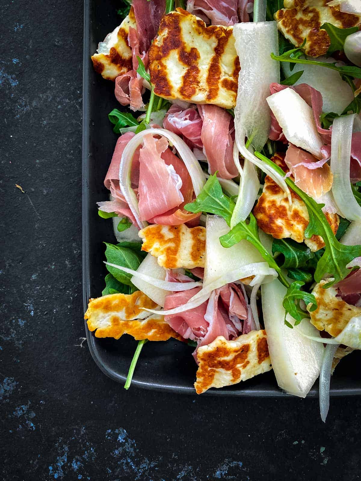 Canary Melon Salad with Halloumi in an oblong platter