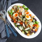 Rotisserie Chicken Salad in an oval platter and blue salad servers