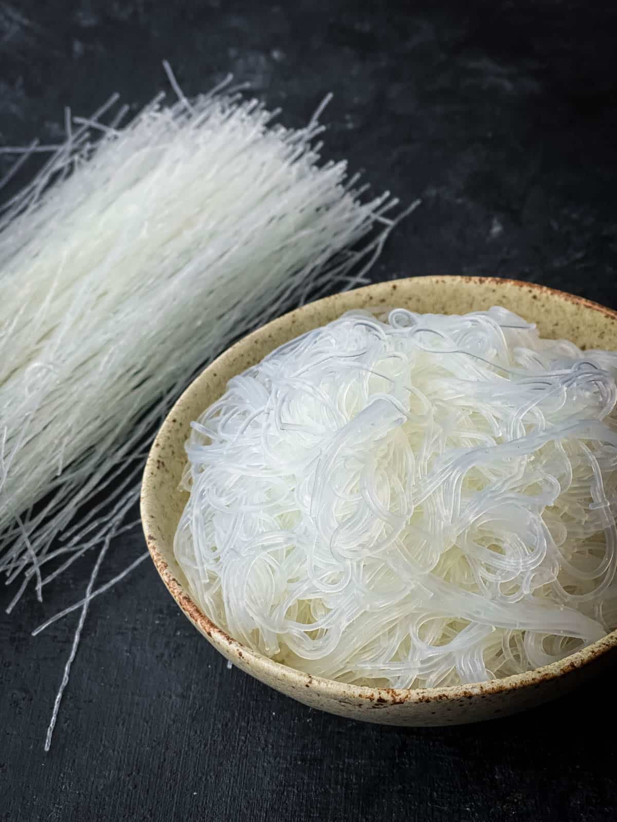 Dry glass noodles and softened glass noodles in a bowl