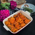 Baked Sweet Potato Slices in a ceramic dish decorated with pink hydrangeas