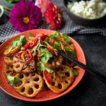 Hot and Sour Stir-Fried Lotus Root served with chopsticks and rice decorated with flowers