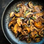 Easy Sauteed Mushrooms with Soy Sage Butter in a black plate