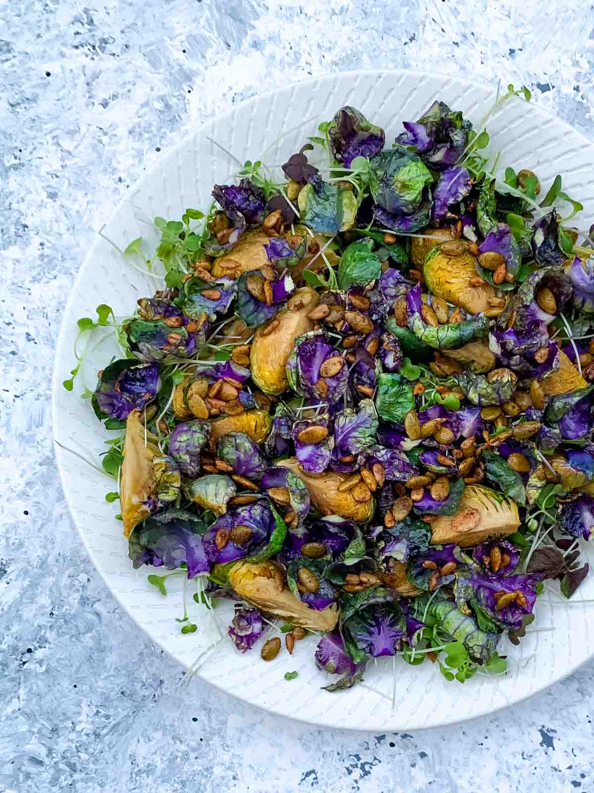 Roasted Purple Brussels Sprouts Salad on a white plate
