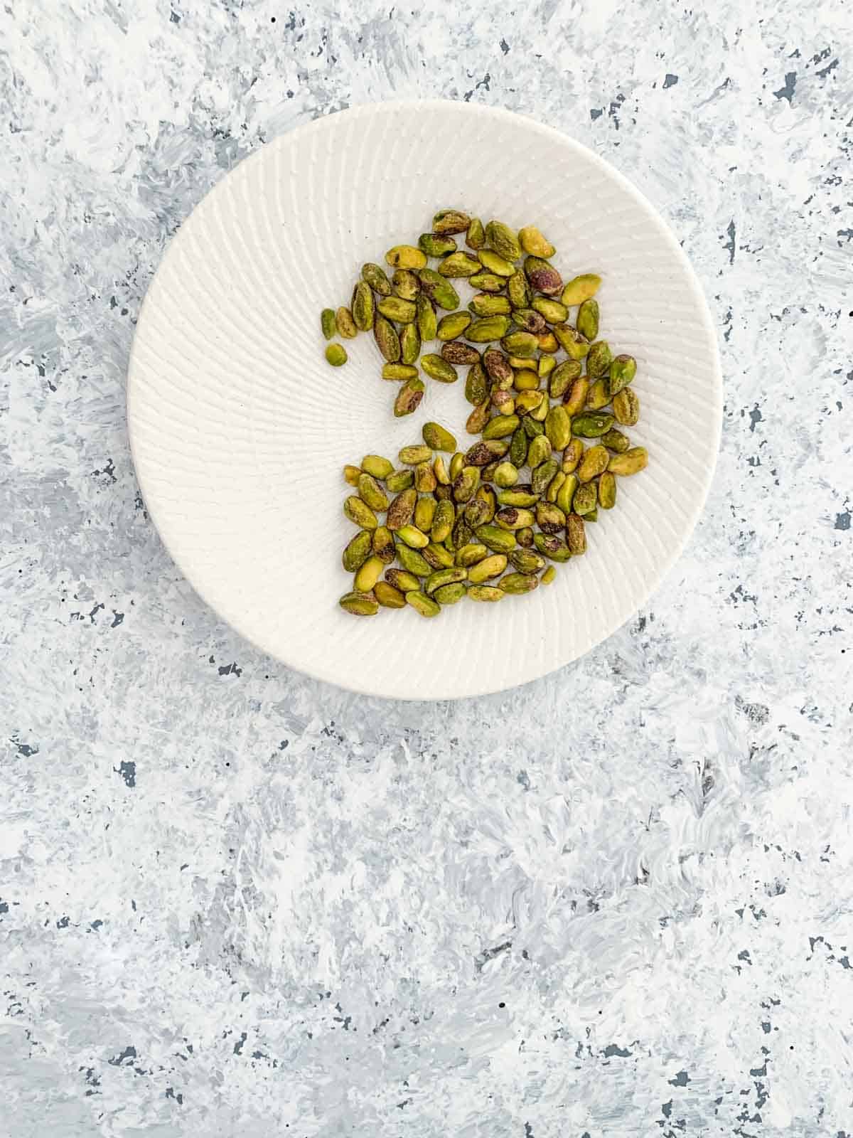 Pistachio kernels on a white plate