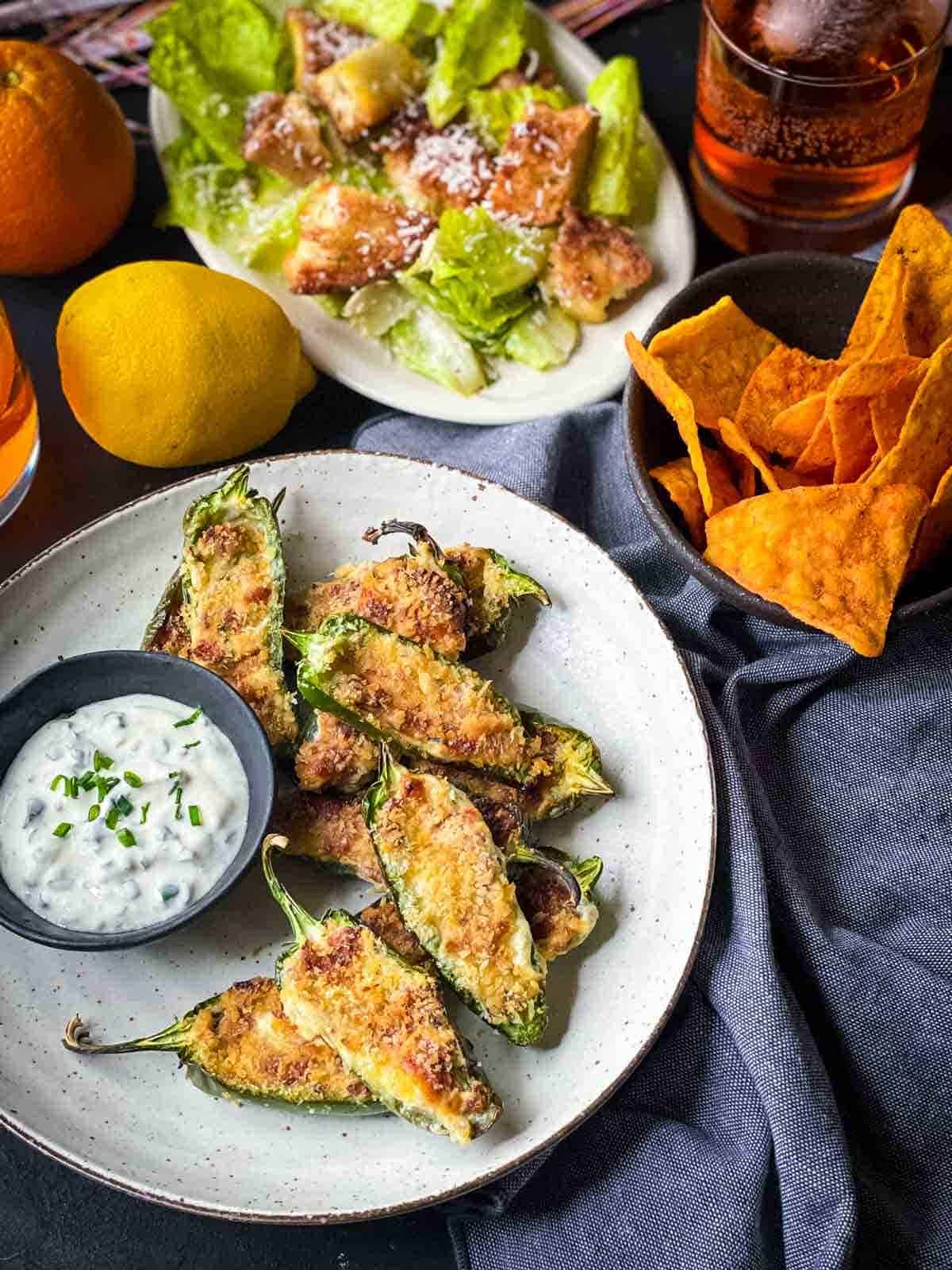 Air Fryer Jalapeno Poppers with sour cream dip served with Caesar salad and corn chips