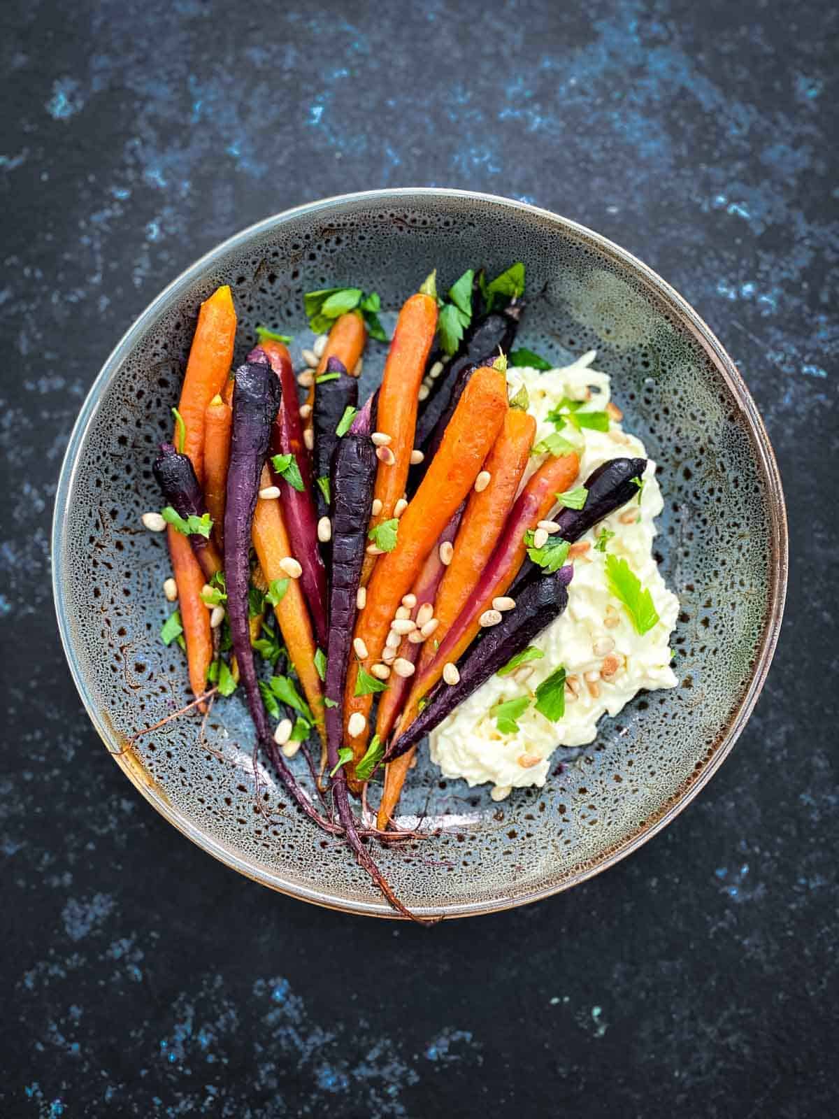 Roasted Maple Carrots with Stracciatella Cheese in a grey bowl