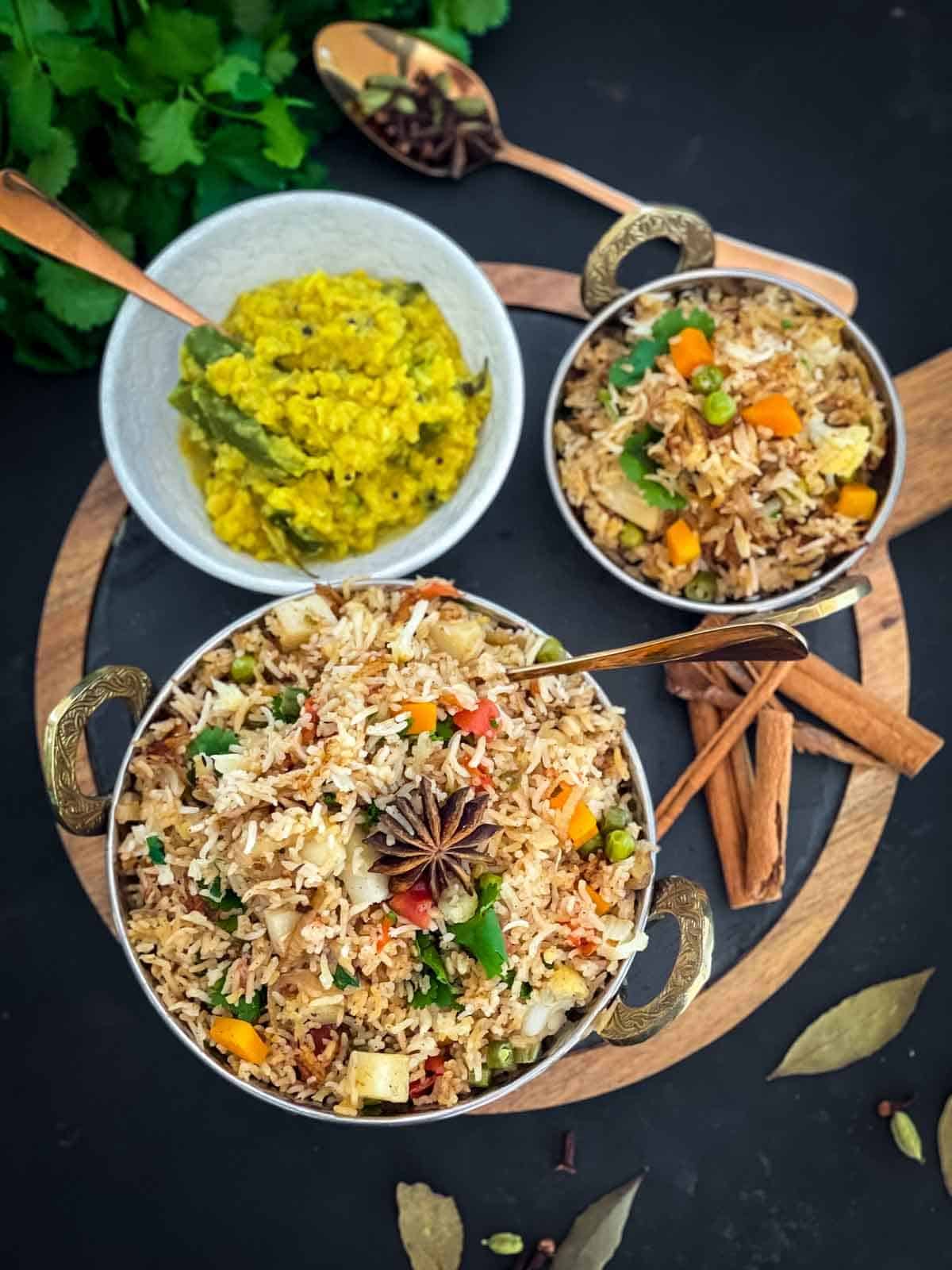 Veg Pulao, Indian Rice Dish, served in a copper kadai served with dahl