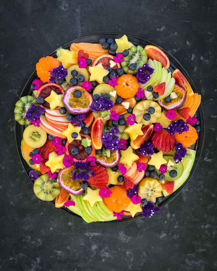 Colourful fruit platter with fruit cut in different shape and sizes