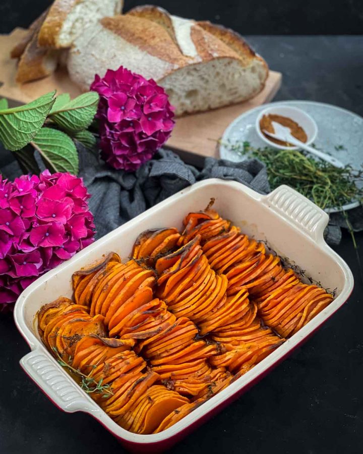 Baked Sweet Potato Slices in a ceramic dish decorated with pink hydrangeas