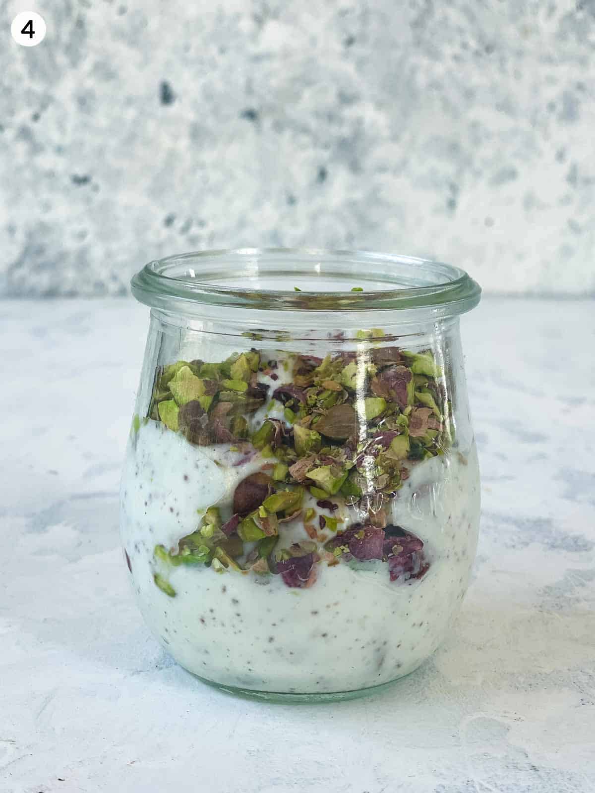 Yoghurt dressing with pistachios in a clear jar