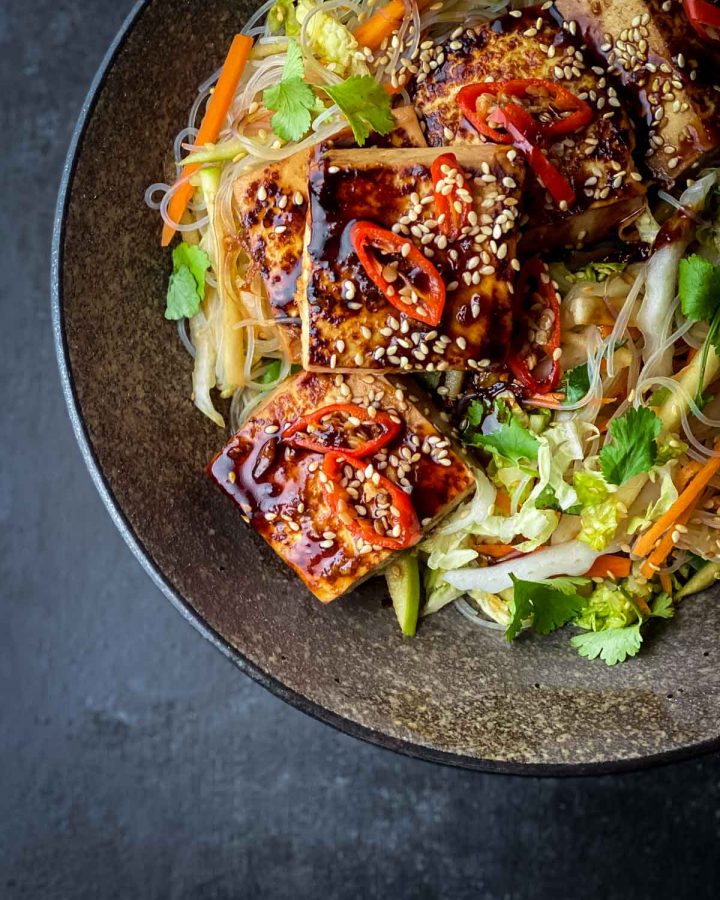 Close up image of Glass Noodle Salad with Sticky Tofu in a brown bowl