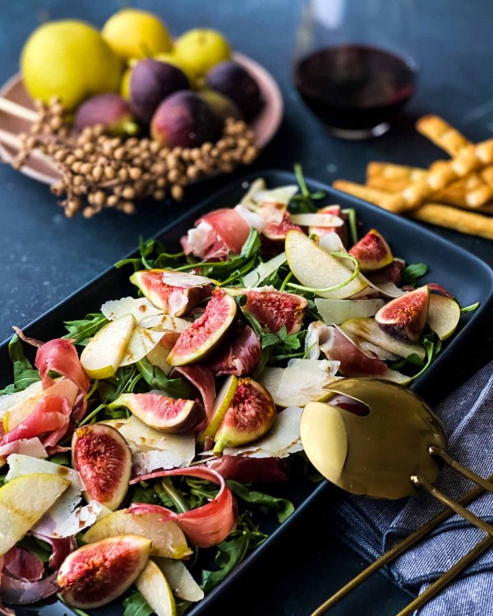 Fig and Prosciutto Salad with Nashi Pear on a rectangular platter served with breadsticks