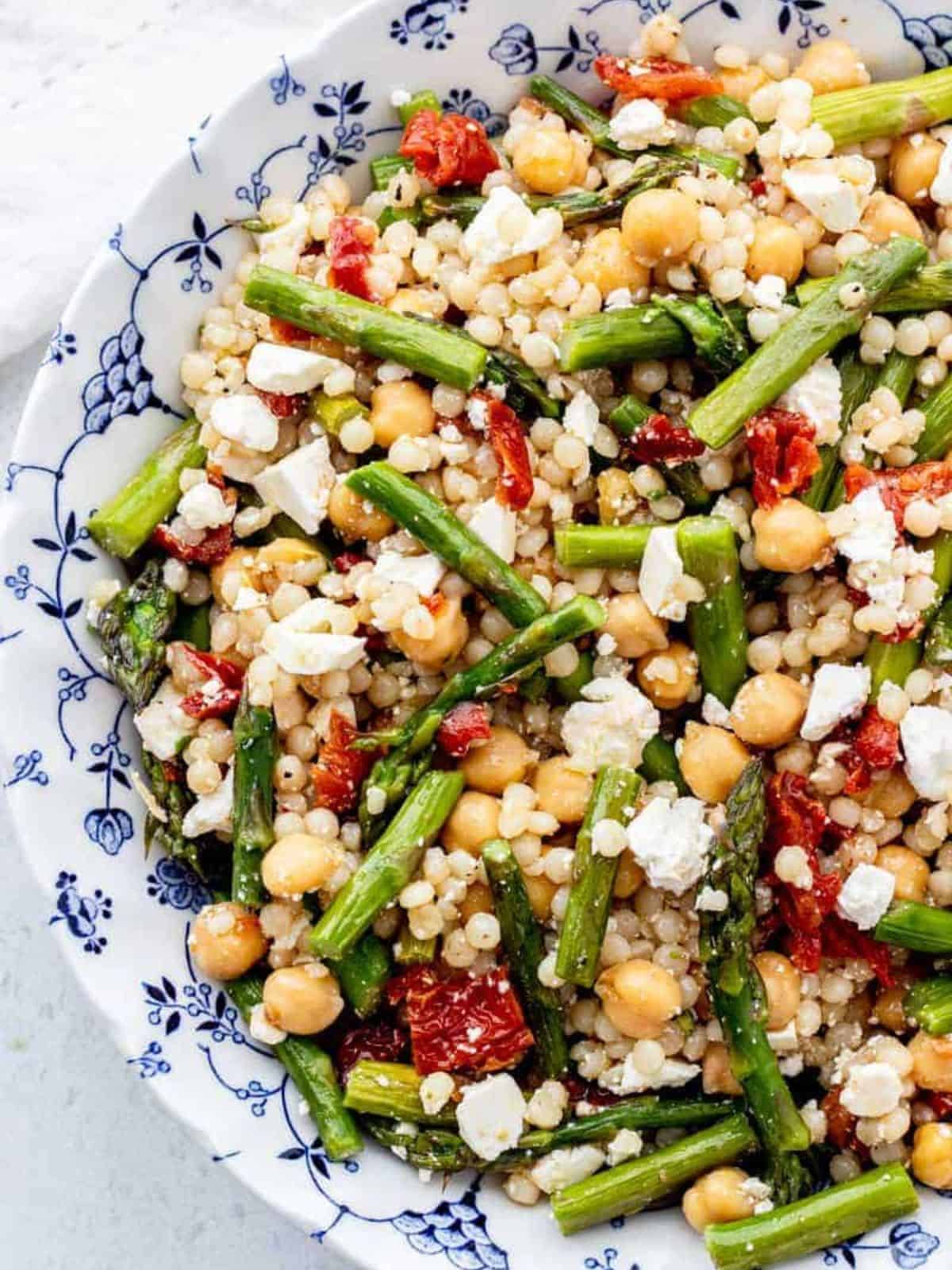 Pearl couscous chickpea salad in a blue floral bowl