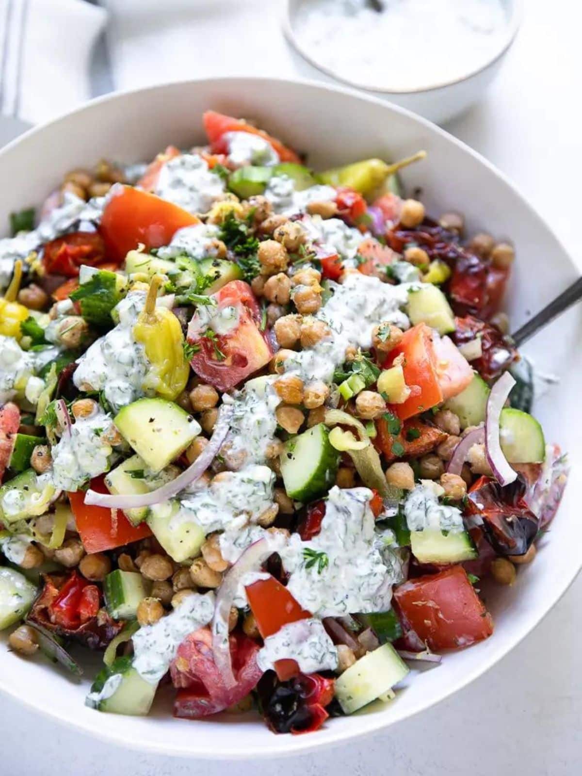 Roasted chickpea tomato salad in a white bowl
