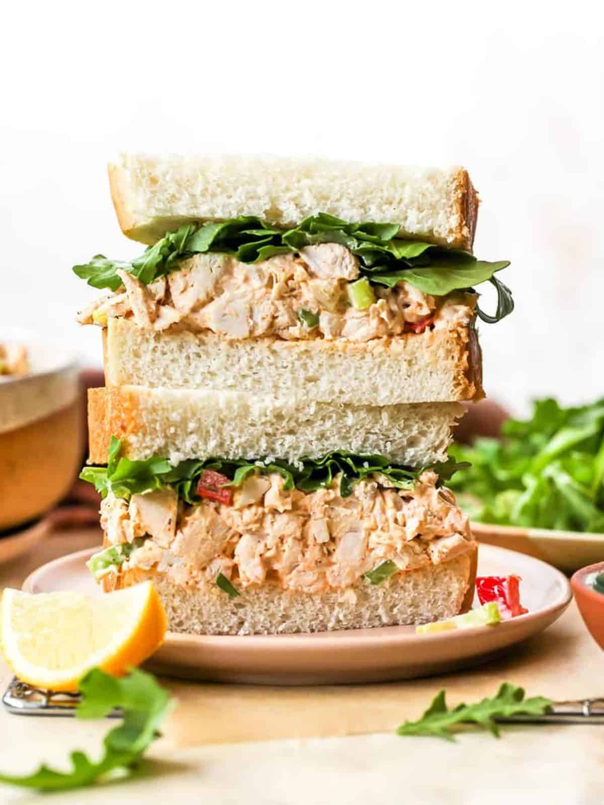 2 stacked chicken salad sandwich on a white plate