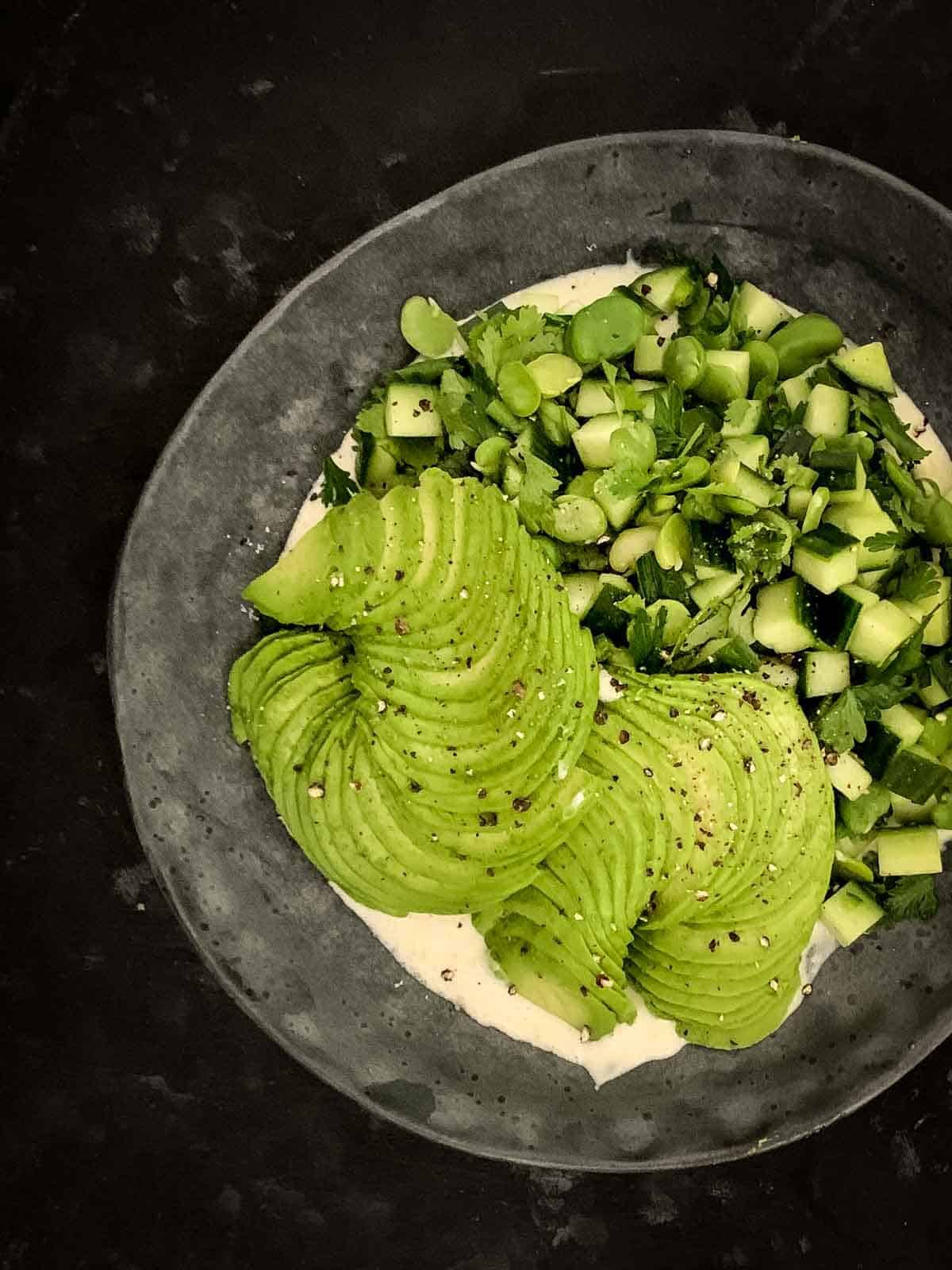 Creamy Cucumber Avocado Salad on a grey plate