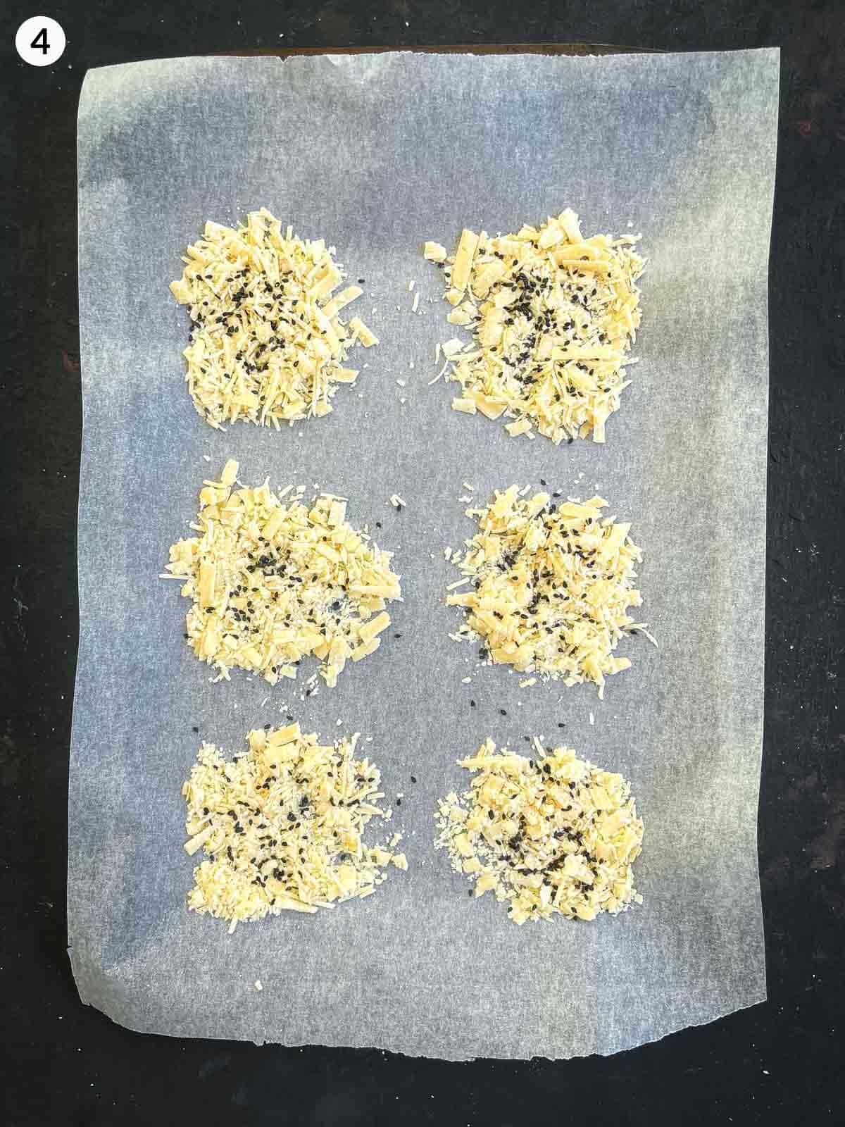 6 parmesan crisps on parchment lined sheet pan