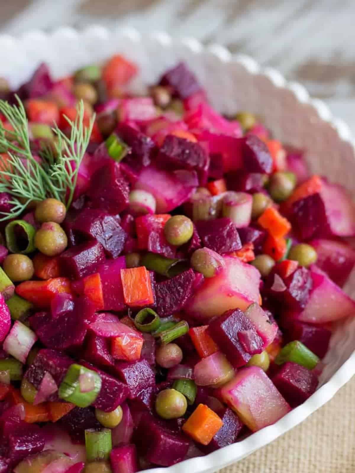 Beet and potato salad in a white bowl