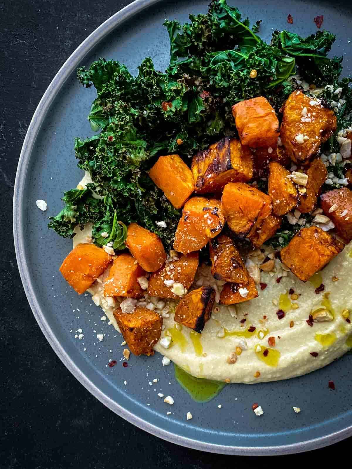 Crispy Kale Salad with Roasted Sweet Potato in a blue bowl