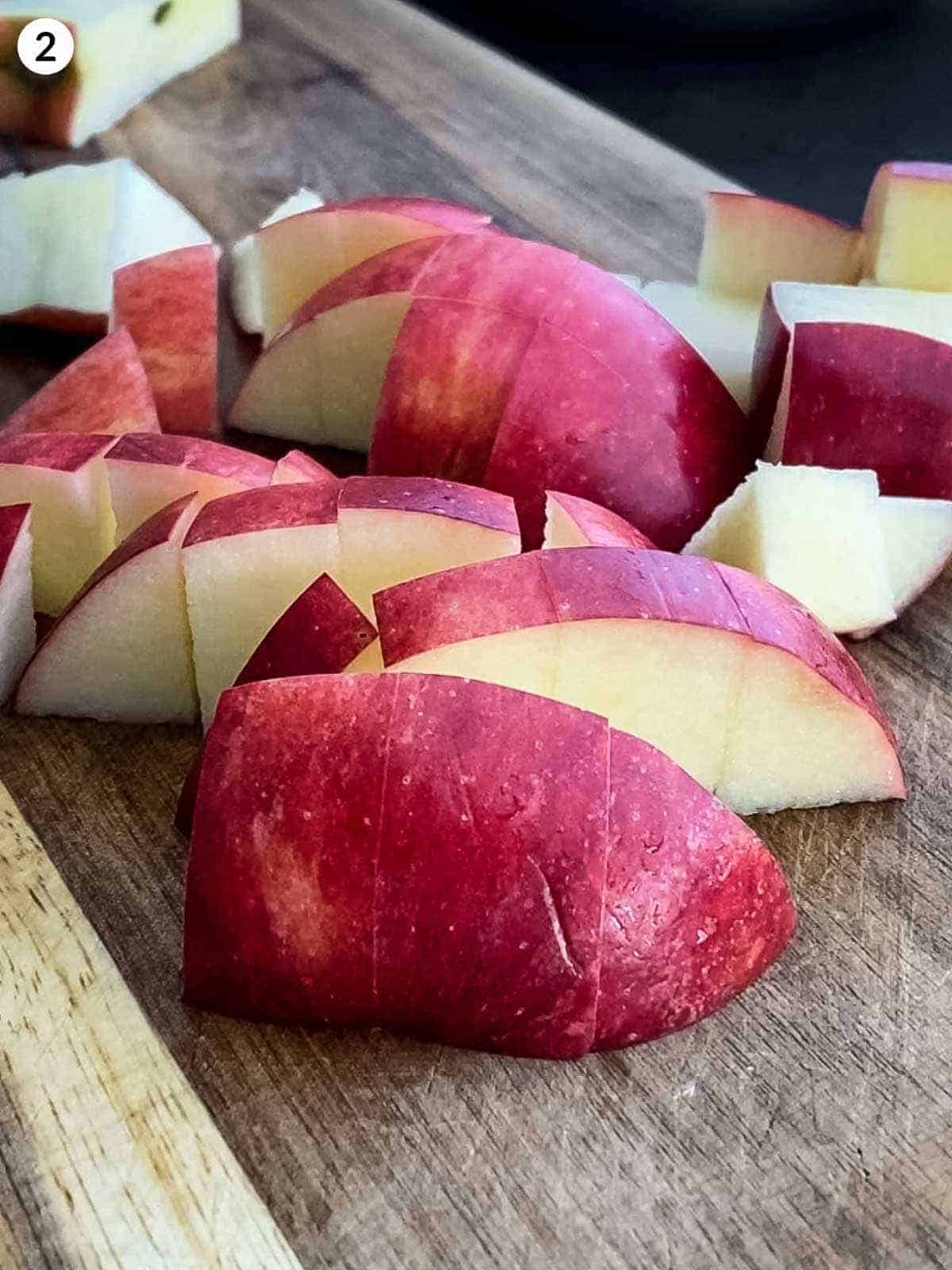 diced apple on a wooden chopping board
