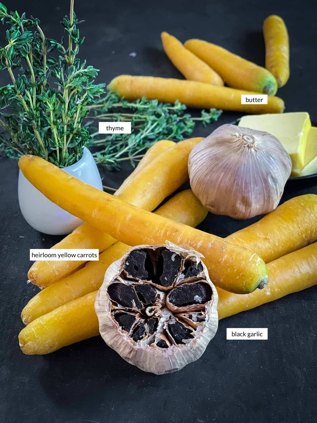 Individually labelled ingredients for Roasted Yellow Carrots with Black Garlic