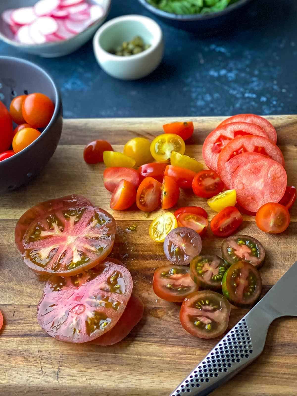 tomato slices on wooden chopping board