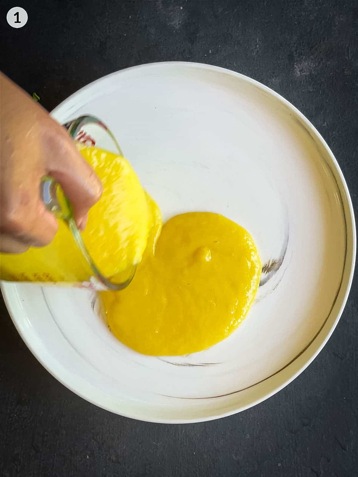 Pouring mango puree onto a plate