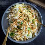 Crunchy Noodle Salad with Cabbage with a gold serving spoons