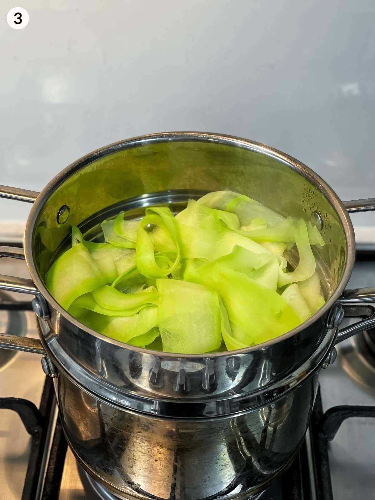cooking strips of Chinese squash in a pot of boiling water