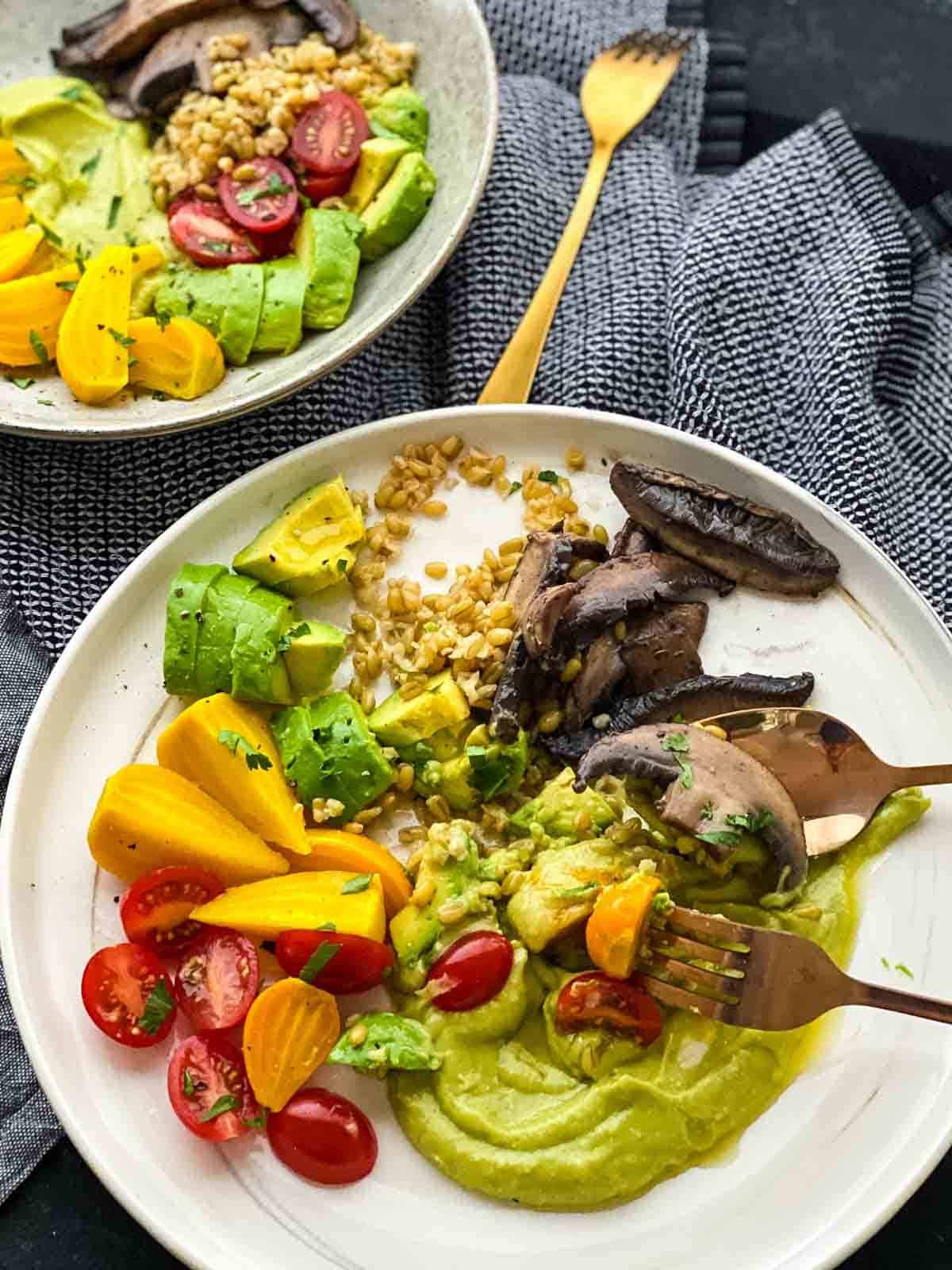 2 serves of Nourish Bowl with Miso Avocado Dressing served with gold cutlery