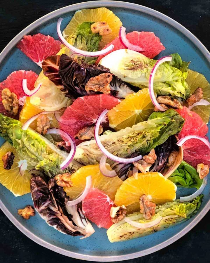 Radicchio, Baby Gem, Orange and Ruby Grapefruit Salad on a blue plate