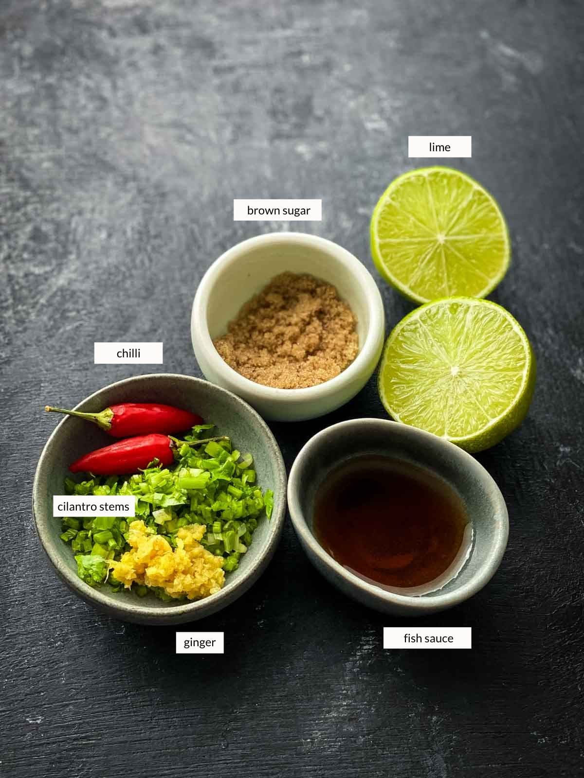 wombok salad dressing ingredients including chilli, chopped cilantro stems, grated ginger, brown sugar, fish sauce and lime