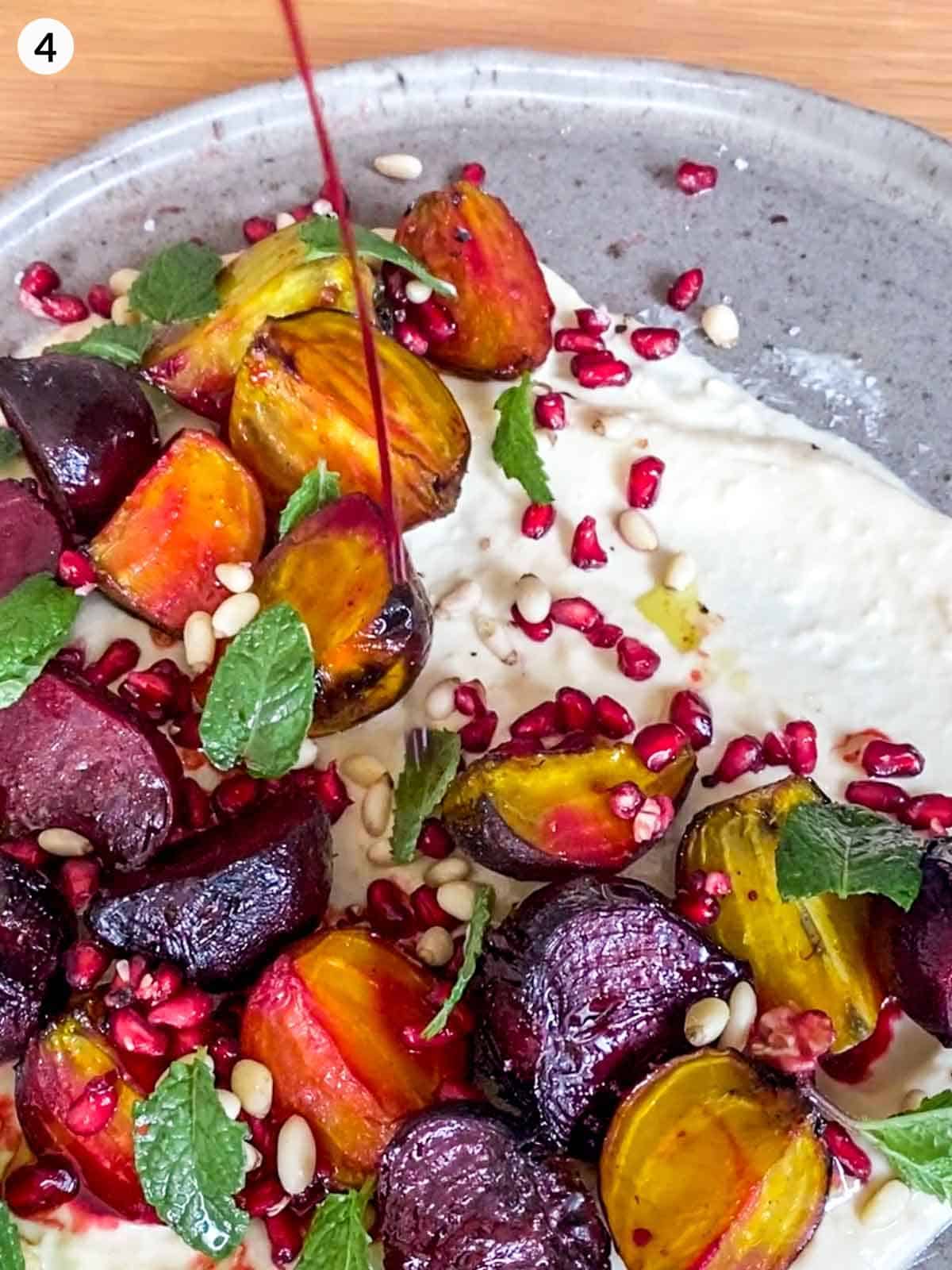Drizzling pomegranate molasses over Roasted Baby Beets with Hummus