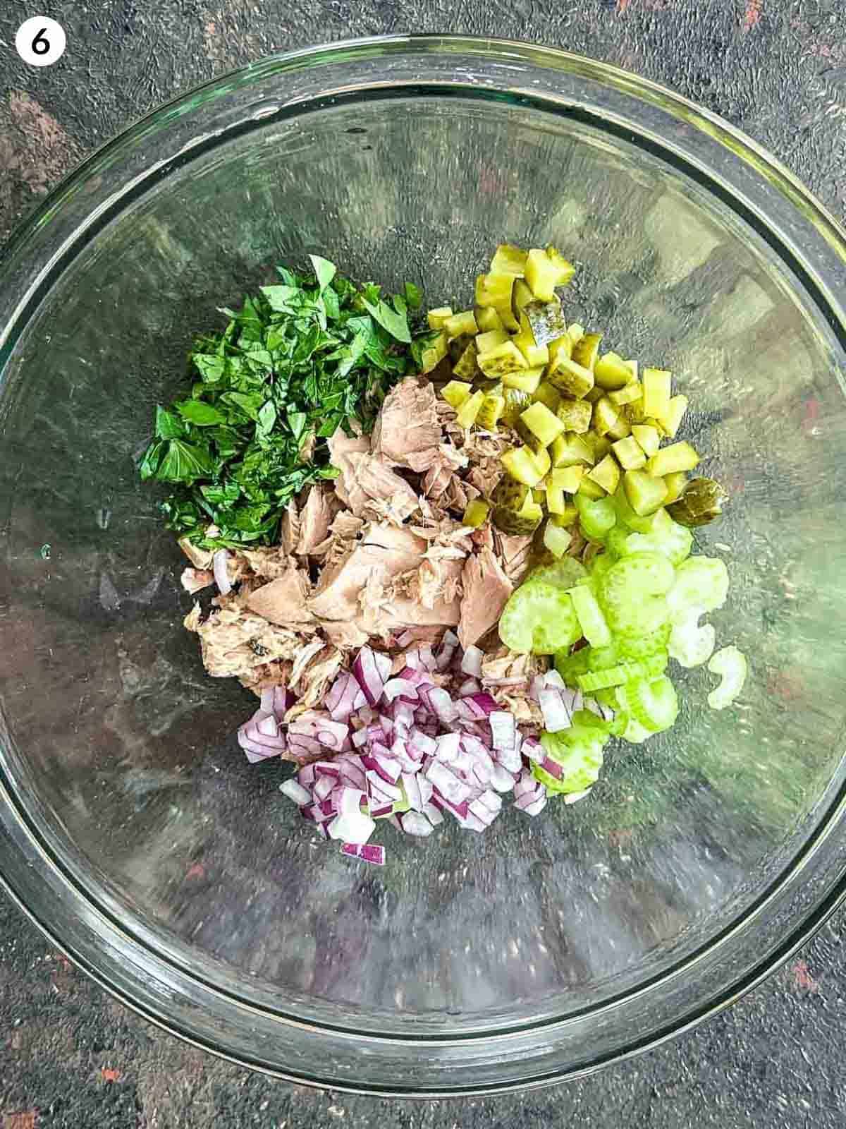 A glass bowl filled with ingredients for healthy tuna salad
