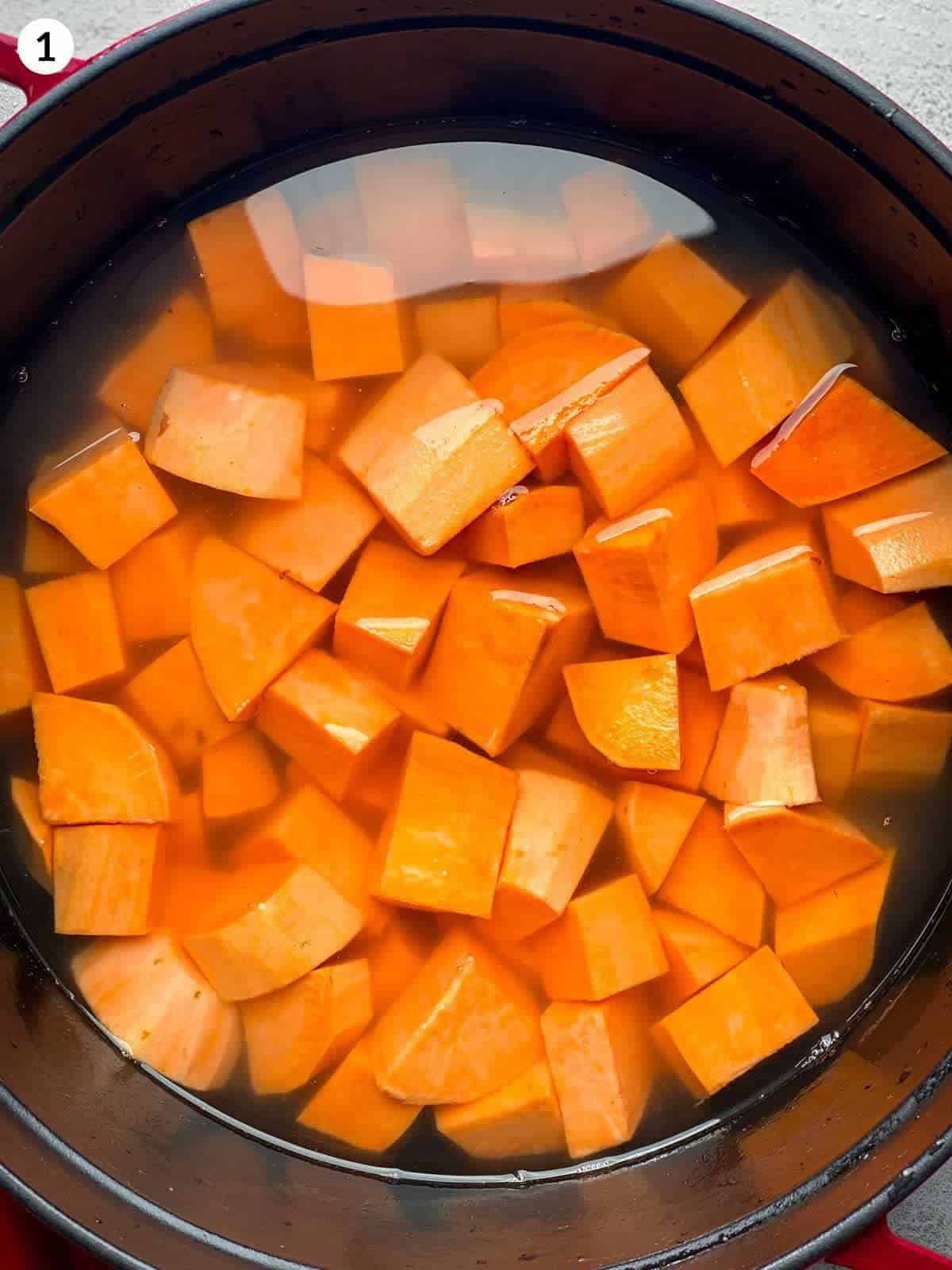 Boiling small pieces of sweet potato in a Dutch oven