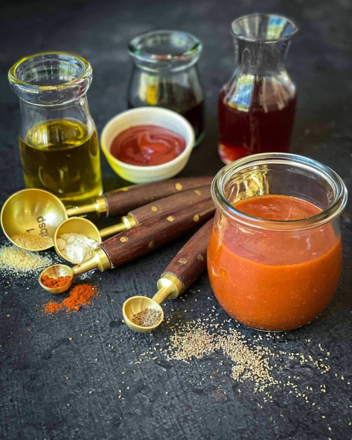 Catalina Dressing in a small jar with oils, vinegars and spices on the side