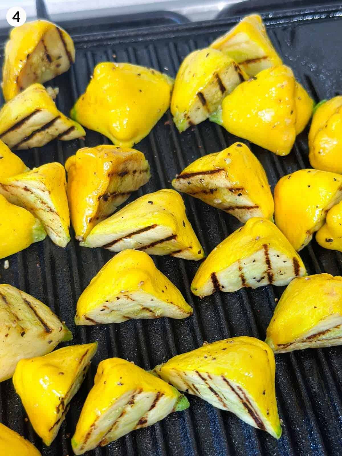 Grilling patty pan squash on a grill plate
