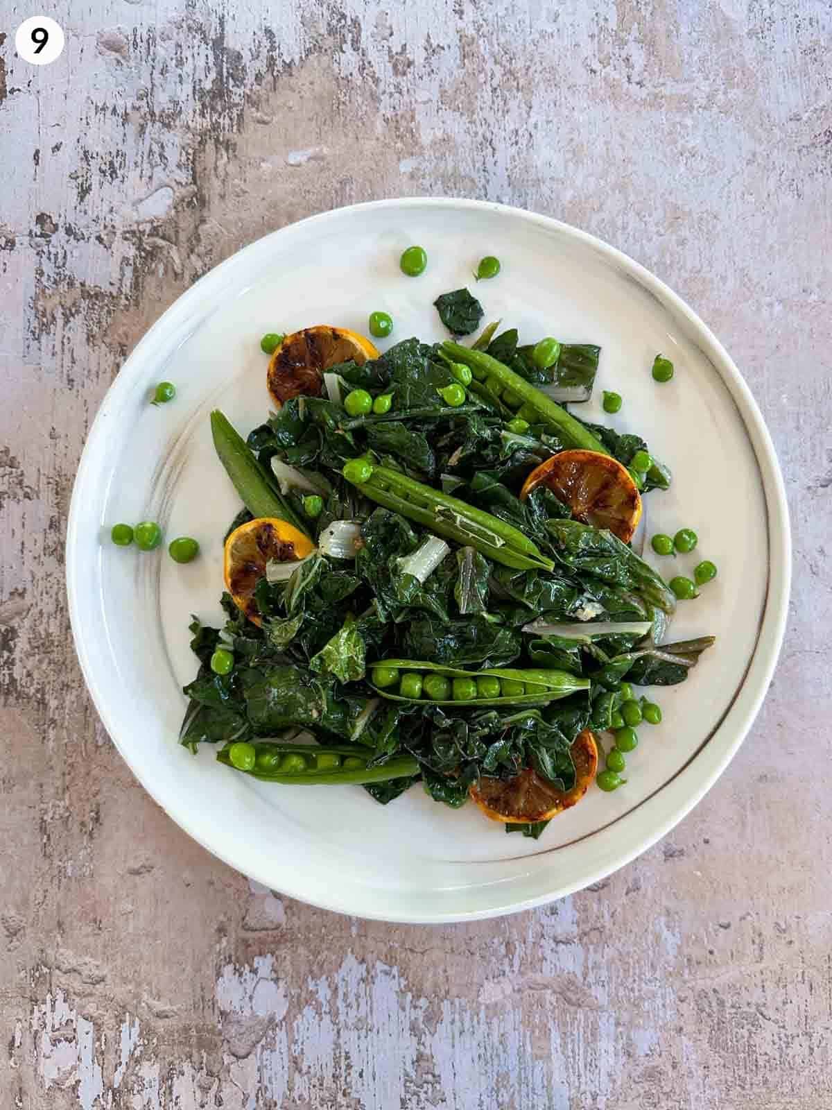 Sautéed Silverbeet with Peas on a white plate